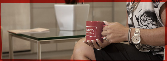 Person with a Vancity coffee mug